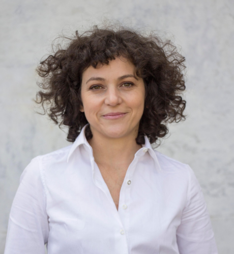 Imagem da pesquisadora Keila Kern. Ela usa uma camisa branca e sorri.